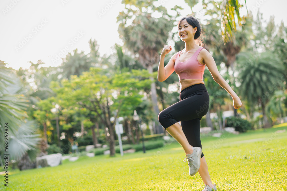 fit Asian woman in her 30s wearing pink sportswear exercises in a public park at sunset. Embrace a healthy outdoor lifestyle and discover the essence of wellness and well-being.