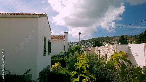 Timelapse of heavy clouds passing by during summer day in Bodrum, Ortakent with summer houses as forefround. photo