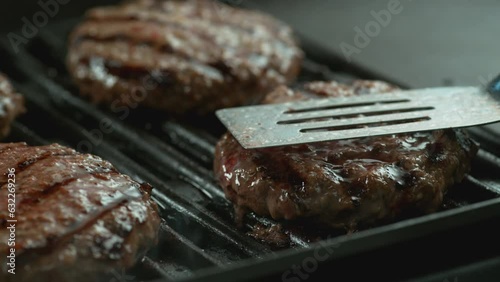 Hamburger on grill in slow motion photo