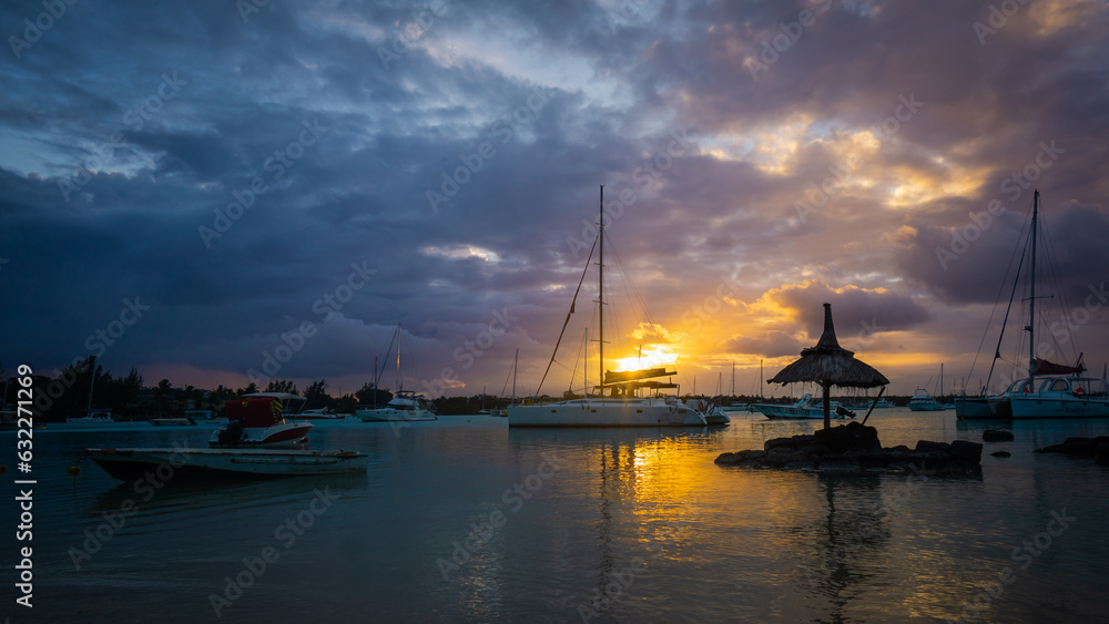 Grand Baie, Mauritius - Beautiful sunset scene of sea and sky with boats in the bay.