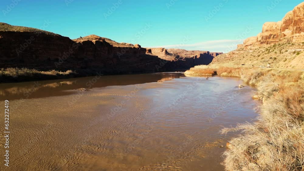 Moab, Utah, where the landscape has been carved by the Colorado River Erosion, looking at the Red Mudded Colorado River Landscape Moab, Utah, where the landscape has been carved by the Colorado River Erosion, looking at the Red Mudded Colorado River Landscape