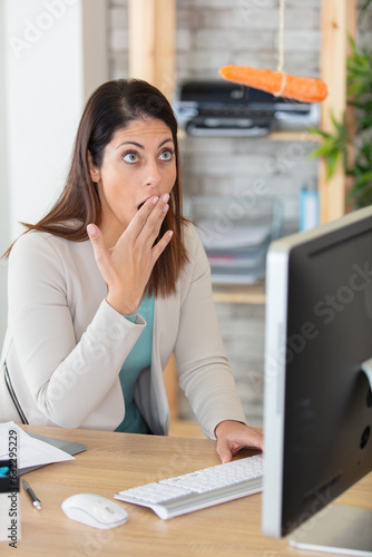 businesswoman yawning working on computer