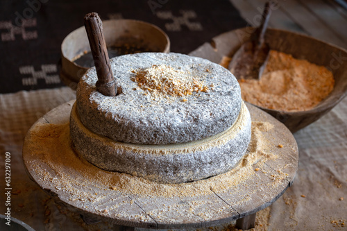Ancient technology of millstones for grinding corn grains and seeds into flour. Ancient grain hand grinding millstones