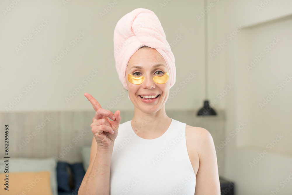 smiling cheerfully, feeling happy and pointing to the side. beauty treatment concept smiling cheerfully, feeling happy and pointing to the side. beauty treatment concept