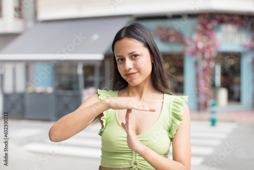 Wallpaper Mural pretty hispanic woman looking serious, stern, angry and displeased, making time out sign Torontodigital.ca