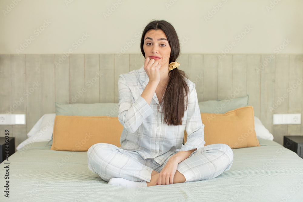 pretty young model feeling scared, worried or angry and looking to the side. rest and nightwear concept pretty young model feeling scared, worried or angry and looking to the side. rest and nightwear concept