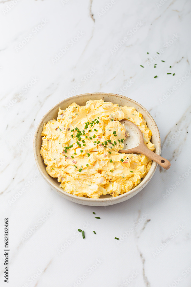 Homemade egg spread with onion, bacon and chives on marble background Homemade egg spread with onion, bacon and chives on marble background