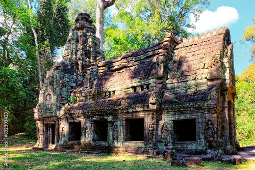 Time's embrace: An old abandoned Khmer building embraced by the Cambodian forest, a testament to medieval Asian architecture, once a house.
