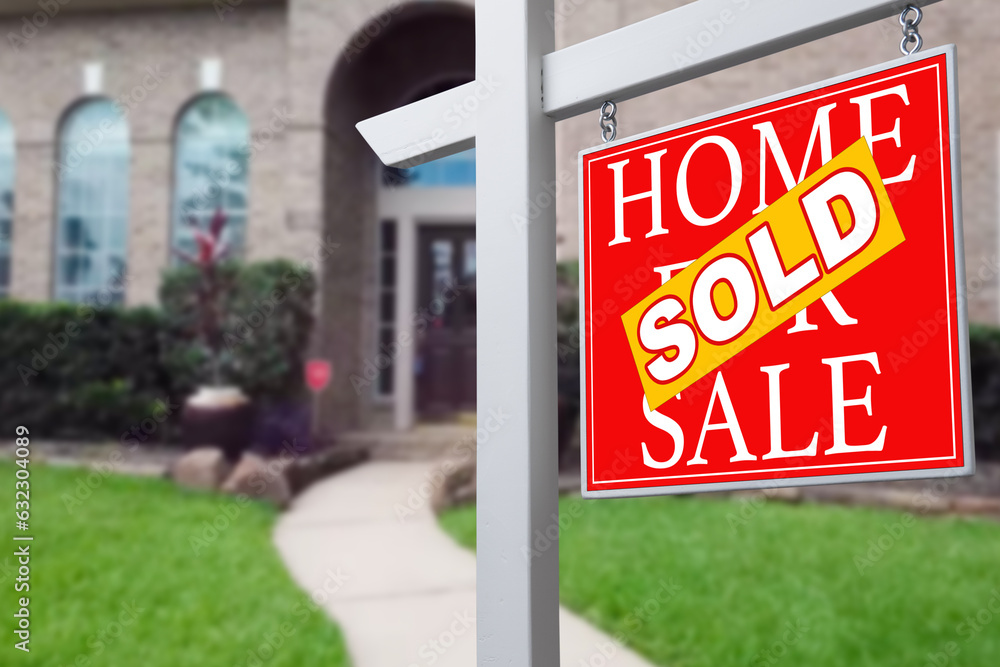 Sold Home For Sale Real Estate Sign in Front of Beautiful New House. Sold Home For Sale Real Estate Sign in Front of Beautiful New House.