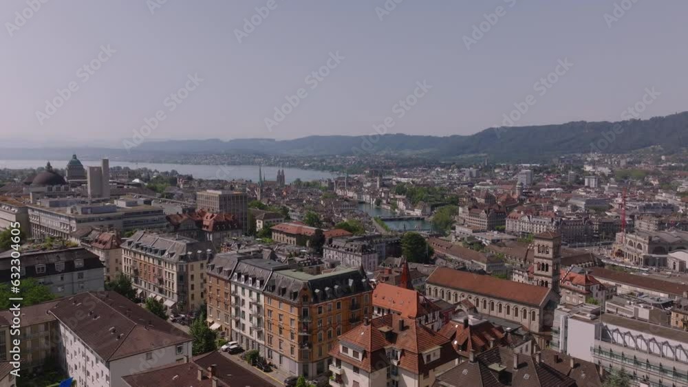 Forwards fly above buildings in urban borough. Aerial panoramic view of city and lake. Zurich, Switzerland Forwards fly above buildings in urban borough. Aerial panoramic view of city and lake. Zurich, Switzerland
