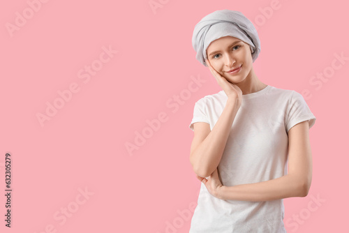 Teenage girl after chemotherapy on pink background