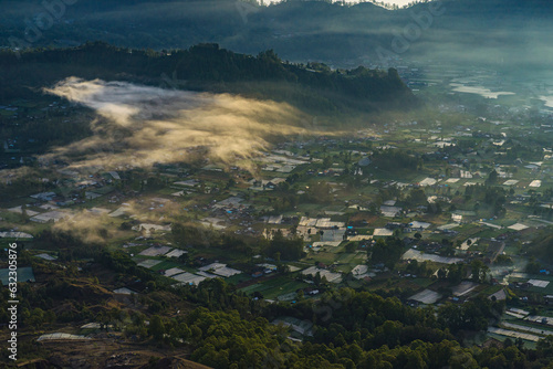 Beautiful landscape view of rural location near the mountain Batur. Morning village at the foot of the mountain