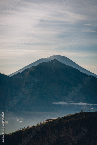 Mountain Batur landscape view in foggy morning. Volcano Batur silhouette with misty and cloudy sky