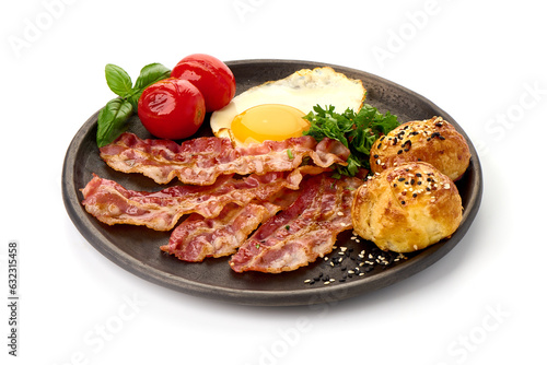 Cooked bacon rashers with egg, close-up, isolated on white background.