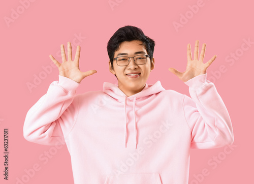 Young Asian man showing han...