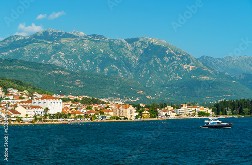 seascapes, a view of the Bay of Kotor during a cruise on a ship in Montenegro, a bright sunny day, mountains and small towns on the coast, the concept of a summer trip