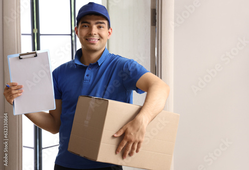 Male courier with parcel an...