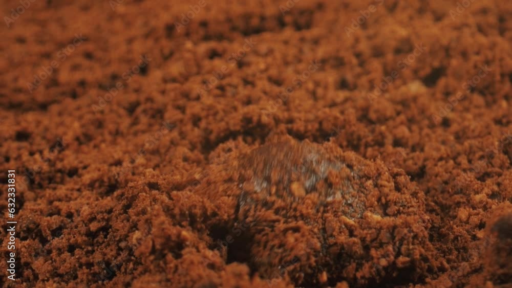 Slow motion of brewing ground coffee with boiling water drops. Pouring hot water onto ground coffee beans. Slow motion of brewing ground coffee with boiling water drops. Pouring hot water onto ground coffee beans.