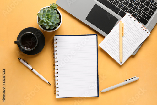 Notebooks with laptop and c...