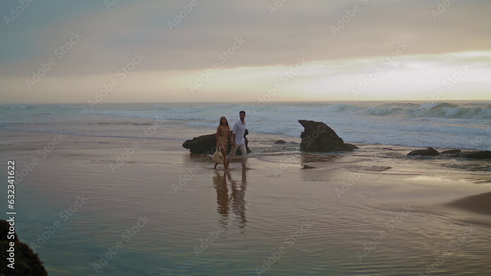 Unknown spouses walking sea beach background. Carefree people enjoying date Unknown spouses walking sea beach background. Carefree people enjoying date