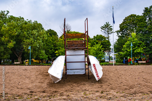 Photography lifguard row boats chained to an observation chair on a beach in the morning