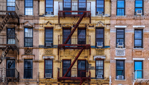 Fototapeta Naklejka Na Ścianę i Meble -  New York building apartment windows - Desktop Background - Fire Escape