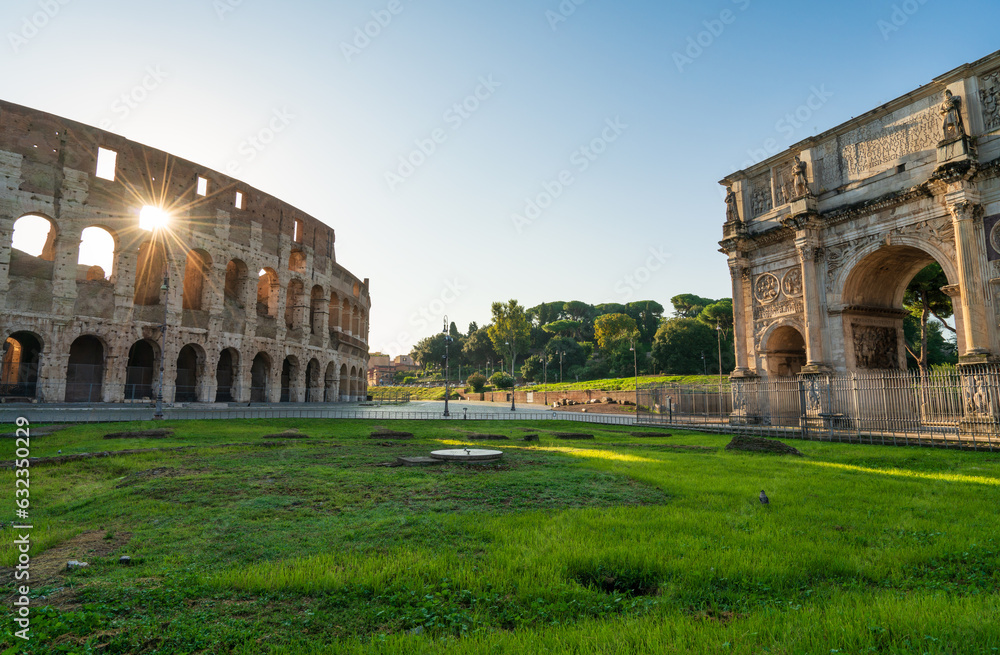 The Arch of Constantine and Colosseum at sunrise in Rome, Italy