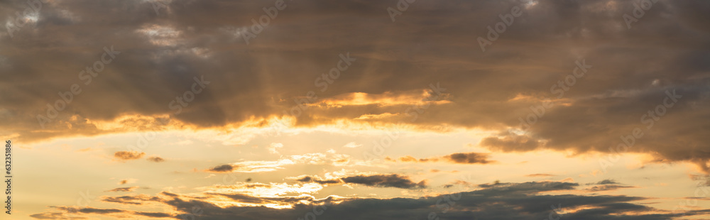 Cloudy sky at sunset with sunrays 