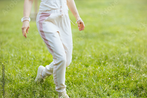 Closeup on female in white shirt walking