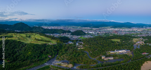 Panoramic Aerial View of Tottori City in Hilly Green Landscape at Dawn