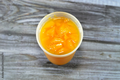 Fresh mango fruit Juice with tropical delicacy, mangoes are nutritionally rich fruit with distinctive flavor, smell, taste, selective focus of Egyptian Mango fruit Juice isolated on wood photo