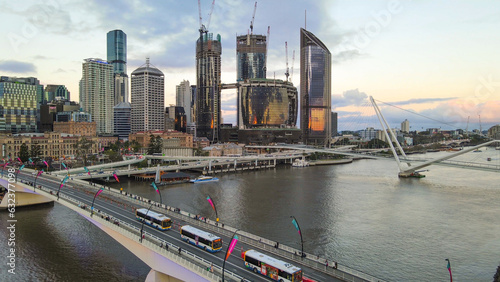 Aerial drone view of Brisbane City, QLD, Australia at Victoria Bridge showing the west facing side of the city along Brisbane River and Riverside Expressway during late afternoon in August 2023   photo