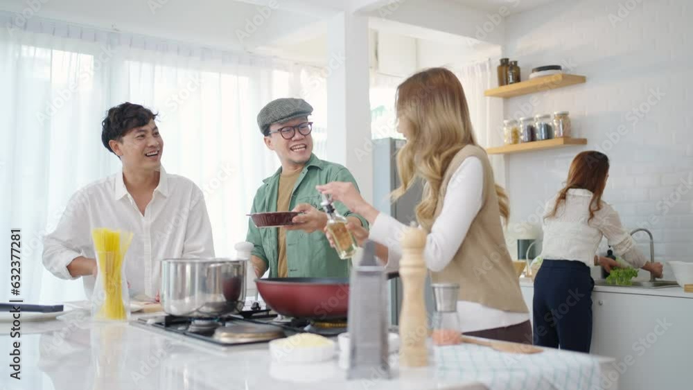 Group of Diversity Asian people cooking healthy food pasta and salad for celebration dinner party together in the kitchen. Cheerful man and woman friend enjoy reunion meeting event on holiday vacation Group of Diversity Asian people cooking healthy food pasta and salad for celebration dinner party together in the kitchen. Cheerful man and woman friend enjoy reunion meeting event on holiday vacation