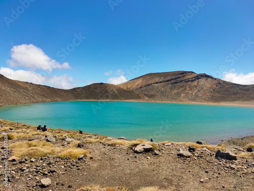 Beautiful view at Tongariro Alpine Crossing, blue sky, mountains, green tosca lake and sunny day.