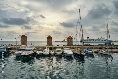 Three medieval windmills standing on the breakwater of the port of Madraki. Greece The city of Rhodes, the island of Rhodes. Recognizable symbol of Rhodes