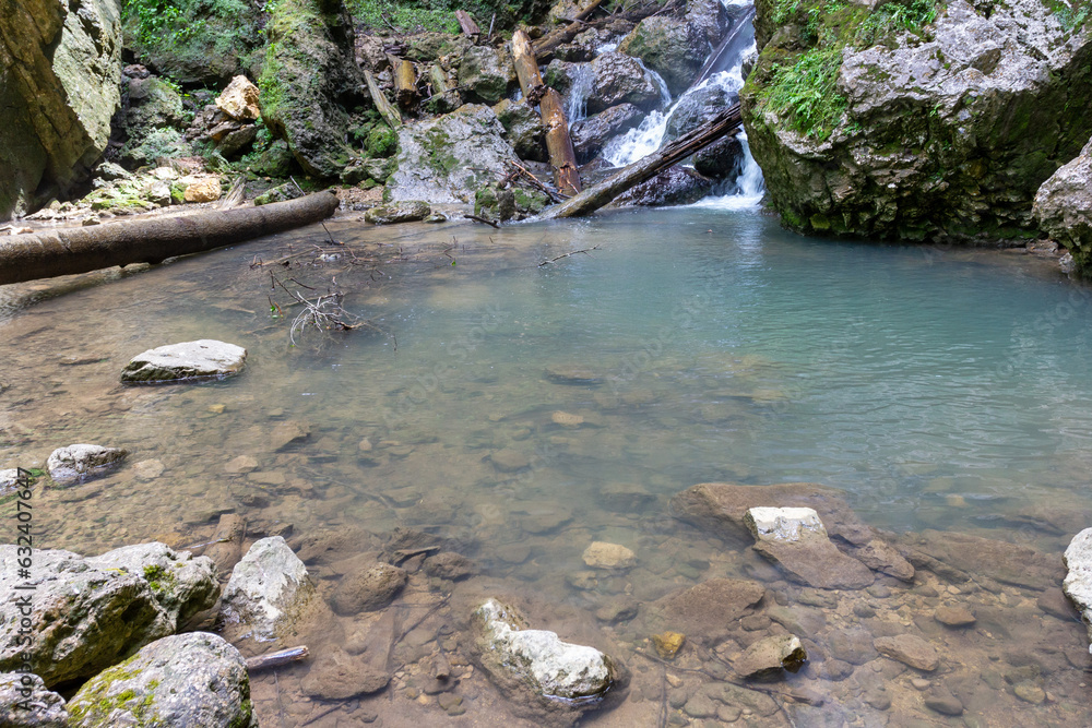 mountain river, waterfall, walking along the canyon , hiking trails and recreation in the mountains.