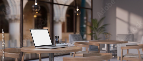 A laptop mockup on a table in a beautiful minimal coffee shop or restaurant.