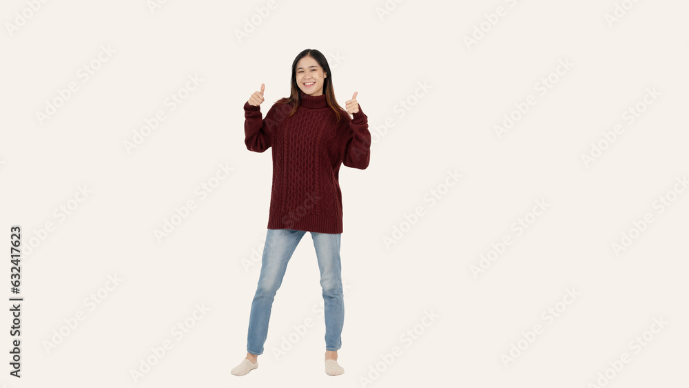 A beautiful Asian woman is showing her thumbs up while standing against an isolated white background A beautiful Asian woman is showing her thumbs up while standing against an isolated white background