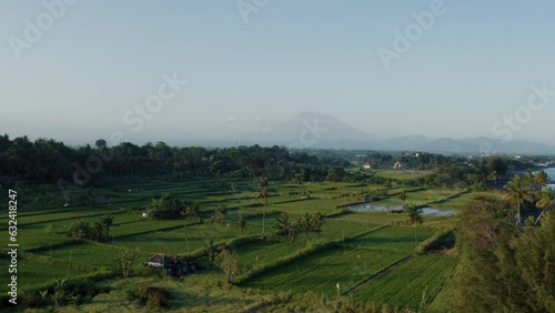 Sunset Over Bali: Aerial Odyssey over Rice Fields, Jungle, and Volcano Silhouette – 4K Drone Captured