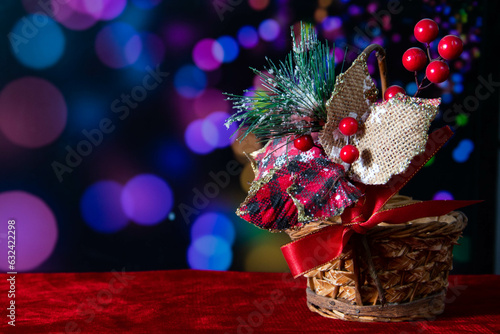 Ixtle and fabric ornament in a small basket, with a background of motif lights. photo