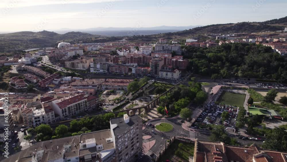 Aerial view circling above Plasencia aqueduct on the outskirts of the walled market city with mountain landscape in the distance Aerial view circling above Plasencia aqueduct on the outskirts of the walled market city with mountain landscape in the distance