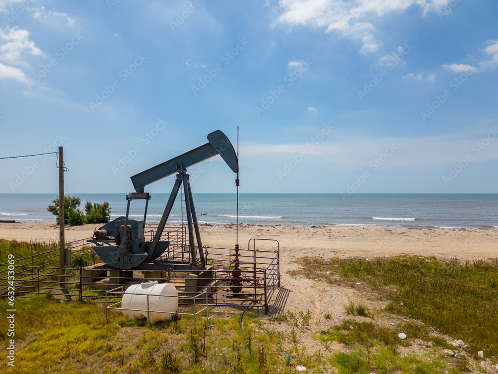 Photo of an old oil pumpjack on High Island Beach Texas Photo of an old oil pumpjack on High Island Beach Texas