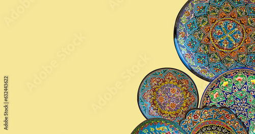 Set of traditional uzbek ceramics, handmade colorful plates. Isolated, solid color background, banner, copy space. Tashkent, Uzbekistan photo