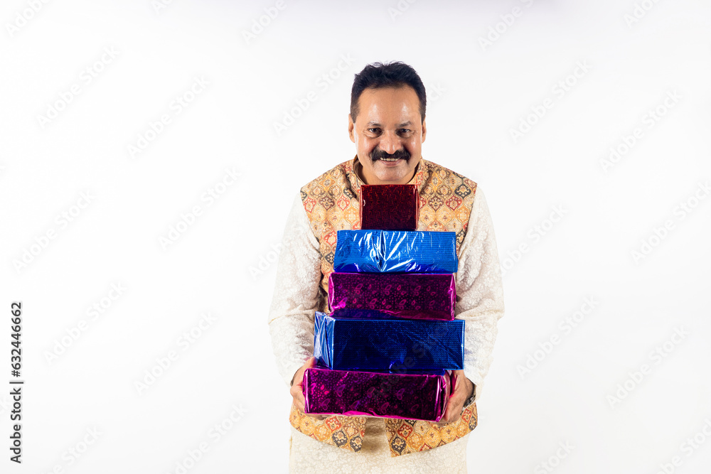 Indian man holding git box in hand on white background. Indian man holding git box in hand on white background.