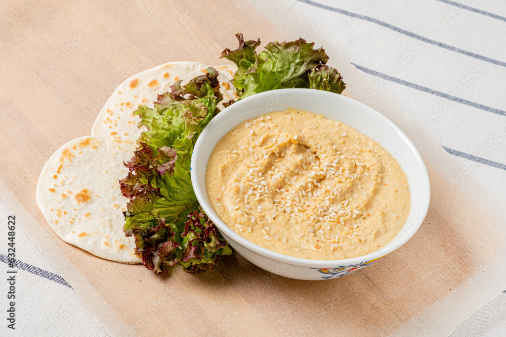 .Chickpeas hummus with flatbread and salad. .Chickpeas hummus with flatbread and salad.