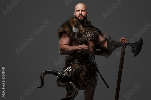A bald, bearded Viking with a fierce appearance wearing fur and light armor, carrying a large axe, against a neutral backdrop