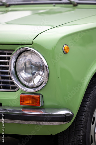 Detail of classic style searchlight of green Lada car, Retro car exhibition Pécs, Hungary - 23. October 2022.