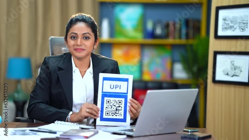 In her office, the Indian woman confidently urges everyone to streamline payments using UPI, highlighting its convenience and efficiency for smoother transactions and enhanced financial processes. photo