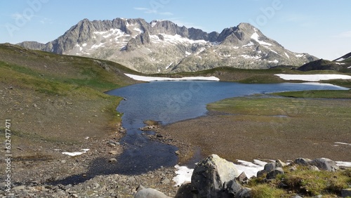  a mountain lake surrounded by snow covered mountains