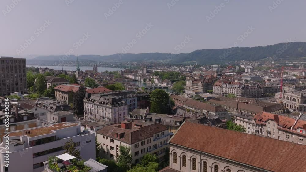 Forwards fly above buildings in urban borough on sunny day. Old multistorey buildings and palaces in city. Zurich, Switzerland Forwards fly above buildings in urban borough on sunny day. Old multistorey buildings and palaces in city. Zurich, Switzerland